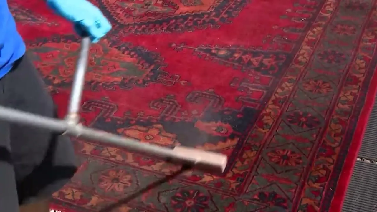 Area rug being professionally cleaned in Austin workshop