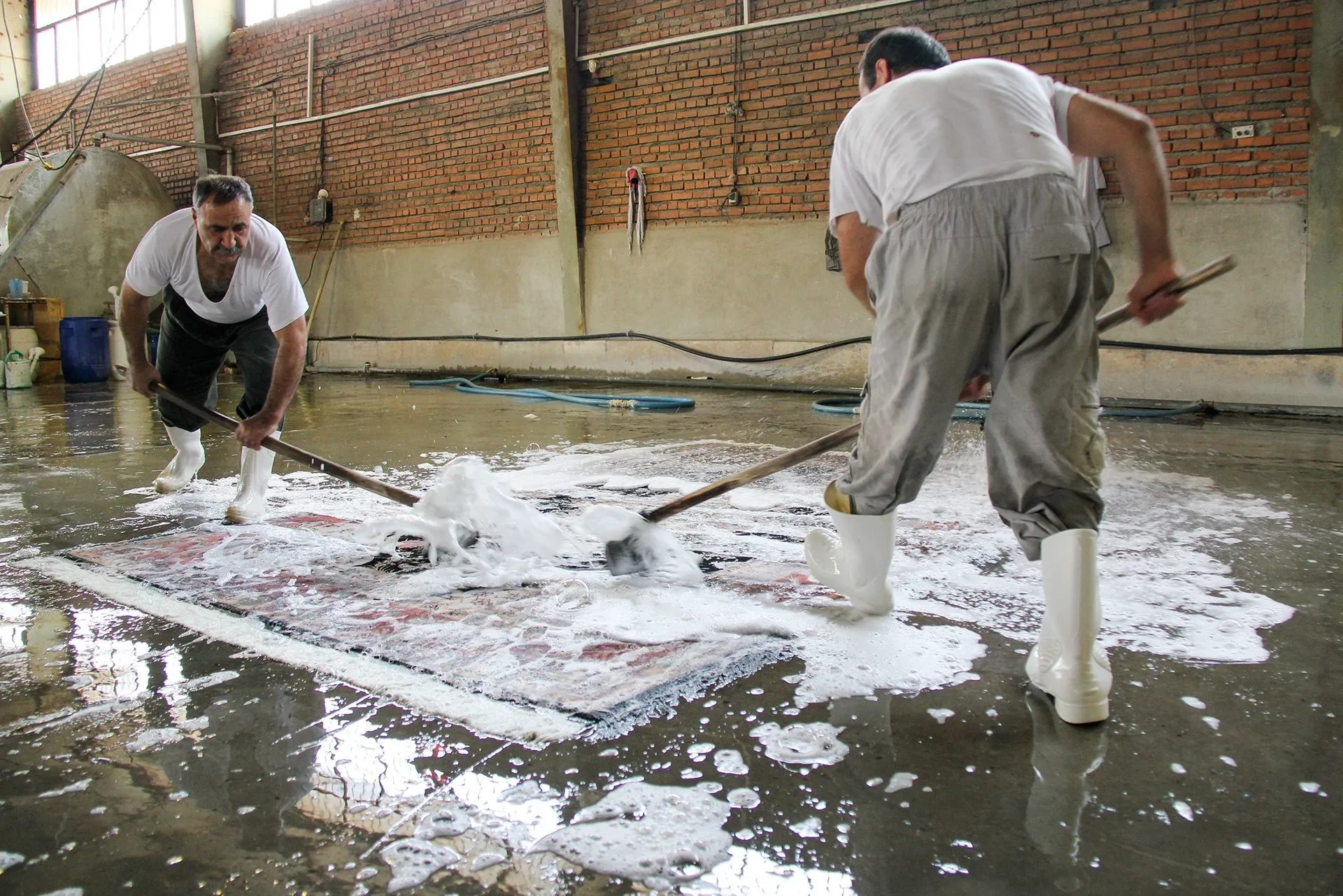 Oriental rug hand washing in cleaning workshop